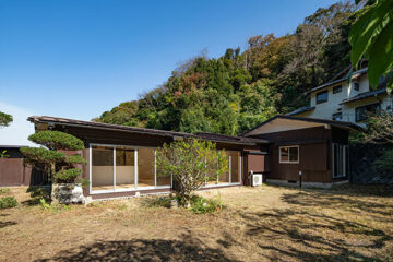color garden 26 がリノベーションを手掛けた鎌倉浄明寺の家の外観。広い庭に古民家がL字型に建っている。裏手には小さい山がある。
